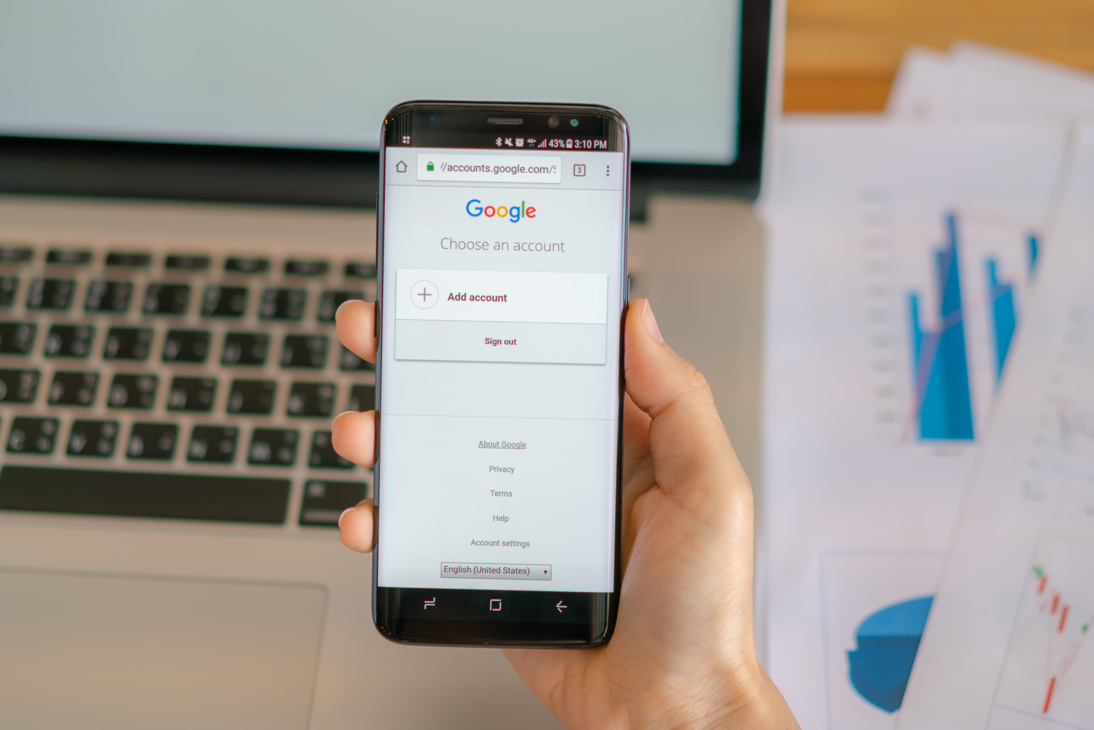 Restaurant owner searching Google on a phone to find a grease trap cleaning service